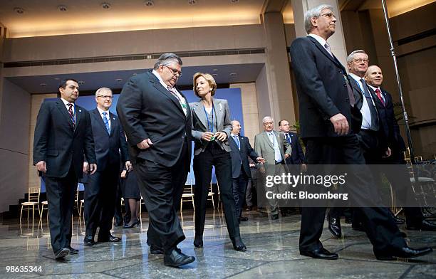 Agustin Carstens, governor of the central bank of Mexico, center left, talks to Elena Salgado, Spain's finance minister, after a group photo during...