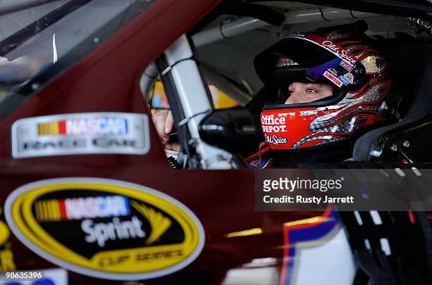 Tony Stewart, driver of the Ols spice Matterhorn Chevrolet, sits in his car in the garage prior to practice for the NASCAR Sprint Cup Series Aaron's...
