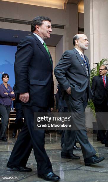 James Flaherty, Canada's finance minister, left, and Ben S. Bernanke, chairman of the U.S. Federal Reserve, leave after a group photo of the Group of...