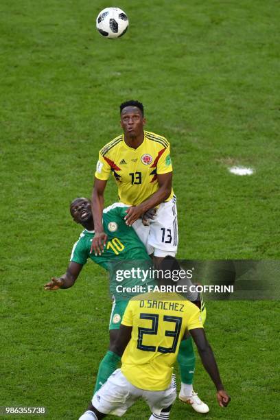 Colombia's defender Yerry Mina jumps for the ball with Senegal's forward Sadio Mane during the Russia 2018 World Cup Group H football match between...