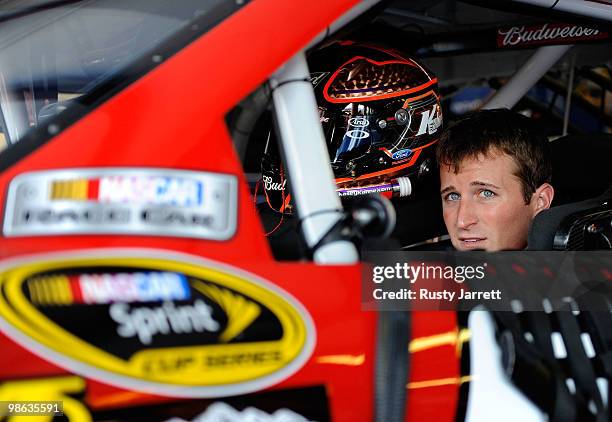 Kasey Kahne, driver of the Budweiser Ford, sits in his car in the garage during practice for the NASCAR Sprint Cup Series Aaron's 499 at Talladega...