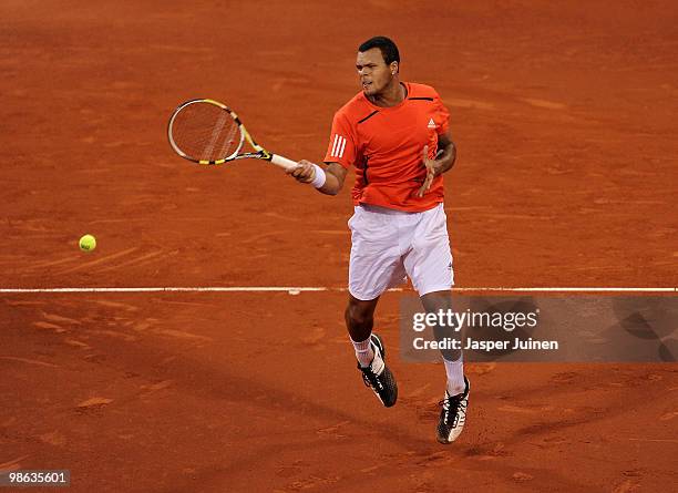 Jo-Wilfried Tsonga of France jumps to play a backhand to Thiemo de Bakker of The Netherlands during the quarter final match on day five of the ATP...