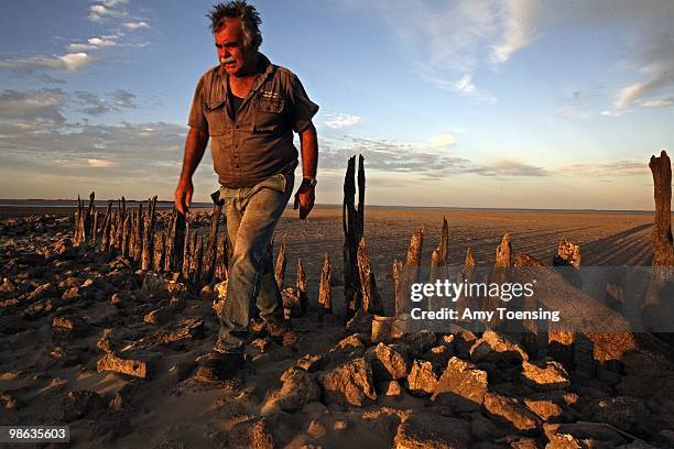 Mick Fischer checks the water level of Lake Albert where he used to get water for his herd of dairy cows March 3, 2008 in Meningie, South Australia,...