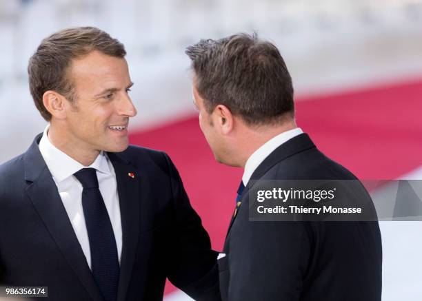 French President Emmanuel Macron is talking with the Luxembourg Prime Minister Xavier Bettel as they arrive for an EU Summit at European Council on...