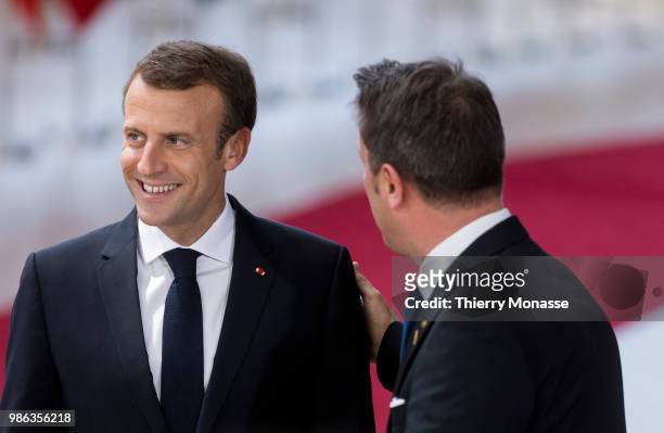 French President Emmanuel Macron is talking with the Luxembourg Prime Minister Xavier Bettel as they arrive for an EU Summit at European Council on...