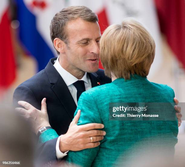 French President Emmanuel Macron greets the German Chancellor Angela Merkel as they arrives for an EU Summit at European Council on June 28, 2018 in...