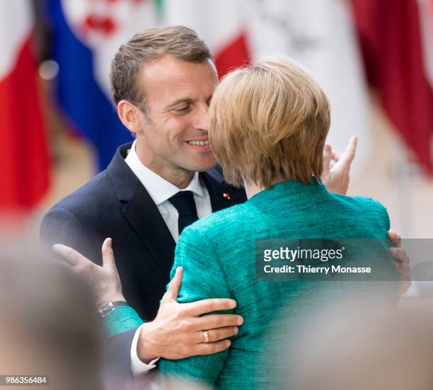 French President Emmanuel Macron greets the German Chancellor Angela Merkel as they arrives for an EU Summit at European Council on June 28, 2018 in...