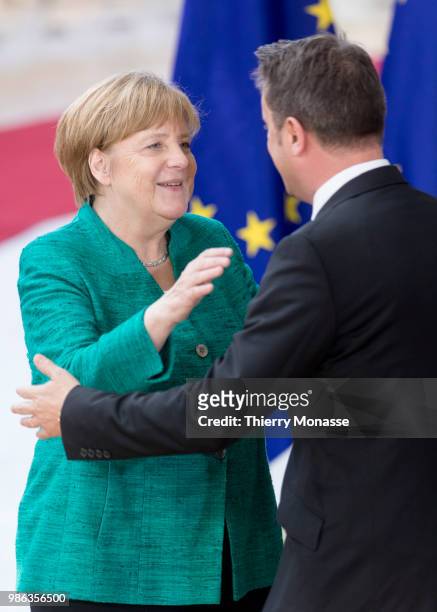 German Chancellor Angela Merkel greets the Luxembourg Prime Minister Xavier Bettel as they arrives for an EU Summit at European Council on June 28,...