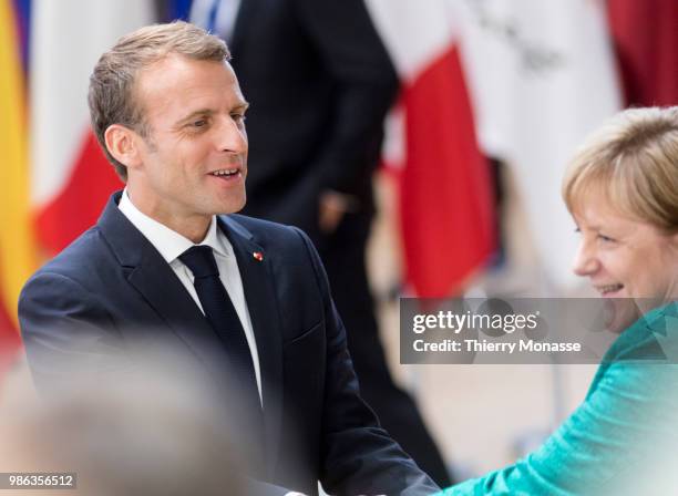 French President Emmanuel Macron greets the German Chancellor Angela Merkel as they arrives for an EU Summit at European Council on June 28, 2018 in...