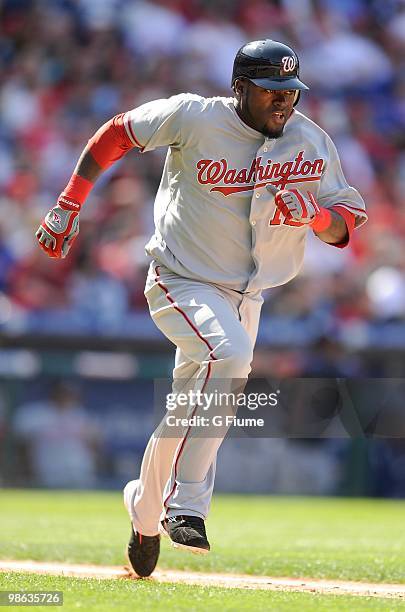 Cristian Guzman of the Washington Nationals runs towards first base against the Philadelphia Phillies on Opening Day at Citizens Bank Park on April...