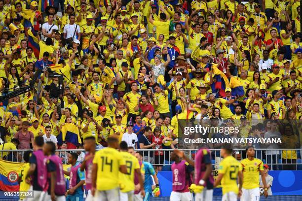 Colombia's team players celebrate with fans after winning with at the end of the Russia 2018 World Cup Group H football match between Senegal and...