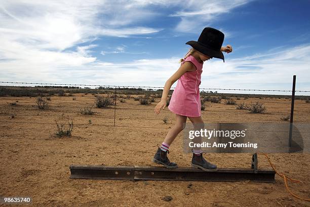 Samantha Turner balances on an I-beam while out on her family's farm, helping her dad mend livestock fences February 10, 2008 in Ivanhoe, New South...