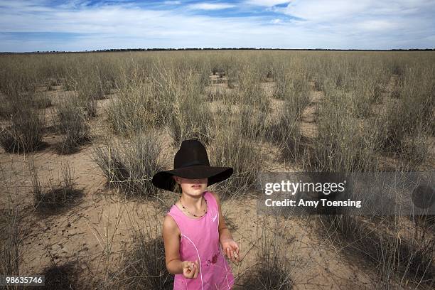 Samantha Turner stands in a paddock while out on her family's farm, helping her dad mend livestock fences February 10, 2008 in Ivanhoe, New South...