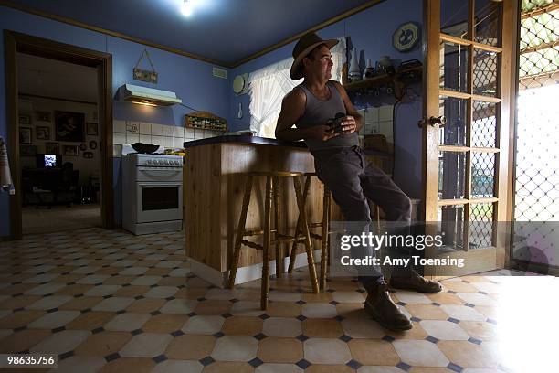 John Butler takes a break in his kitchen after hand-feeding his heard of sheep February 6, 2008 at The Vale in New South Wales, Australia. Normally...