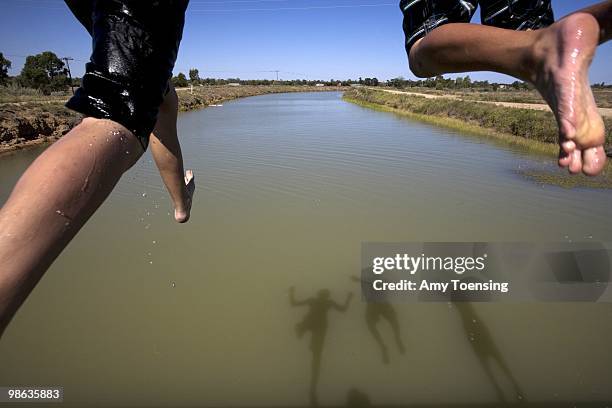 Boys jump off a bridge into the Mulwala Canal February 16, 2008 in Deniliquin, New South Wales, Australia. The Mulwala Canal is the largest...