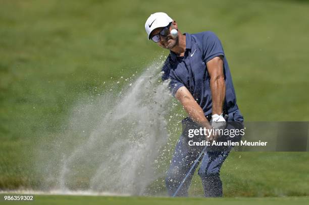 Trevor Immelman of South Africa swings out of a bunker during day one of the HNA Open de France at Le Golf National on June 28, 2018 in Paris, France.