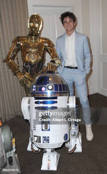 Actor Max Charles poses with C3PO and R2D2 at the After Party at the Academy Of Science Fiction, Fantasy & Horror Films' 44th Annual Saturn Awards...