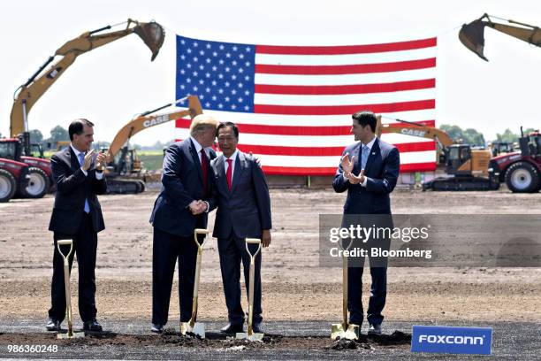 President Donald Trump, second left, shakes hands with Terry Gou, chairman of Foxconn Technology Group, second right, as Scott Walker, governor of...