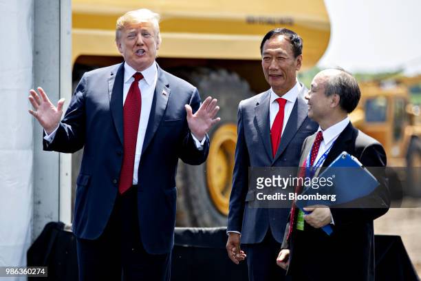 President Donald Trump, left, speaks to the media while standing with Terry Gou, chairman of Foxconn Technology Group, center, and Masayoshi Son,...