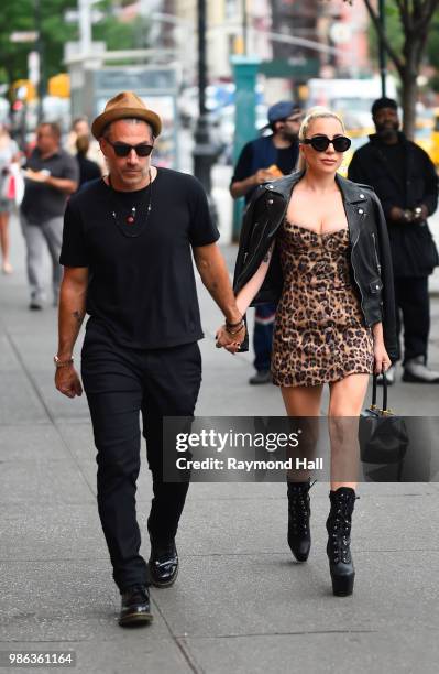 Singer Lady Gaga and Christian Carino are seen walking in SoHo on June 28, 2018 in New York City.