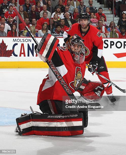 Pascal Leclaire of the Ottawa Senators makes a blocker save against the Pittsburgh Penguins as Matt Cullen looks on in Game Four of the Eastern...