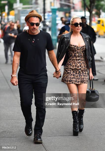 Singer Lady Gaga and Christian Carino are seen walking in SoHo on June 28, 2018 in New York City.