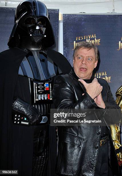 Actor Mark Hamill poses with Darth Vader as he attends a Tribute to Star Wars V during the 18th Adventure Film Festival at Le Grand Rex on April 23,...