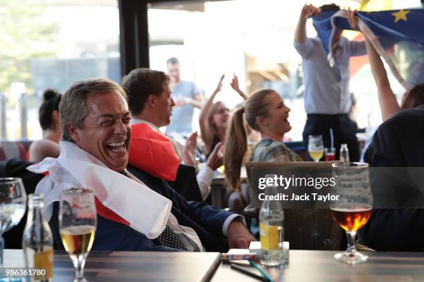 Member of the European Parliament and former Leader of the UK Independence Party Nigel Farage watches England take on Belgium in a World Cup match...