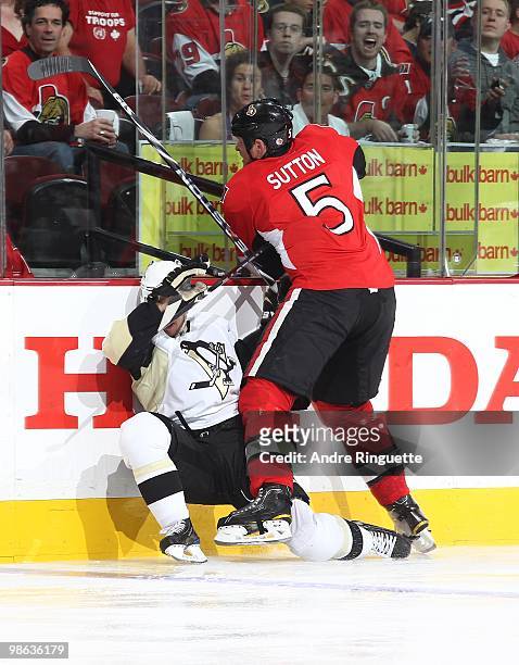 Andy Sutton of the Ottawa Senators throws a bodycheck into Tyler Kennedy of the Pittsburgh Penguins in Game Four of the Eastern Conference...