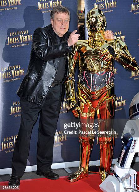 Actor Mark Hamill poses with C-3PO as he attends a Tribute to Star Wars V during the 18th Adventure Film Festival at Le Grand Rex on April 23, 2010...