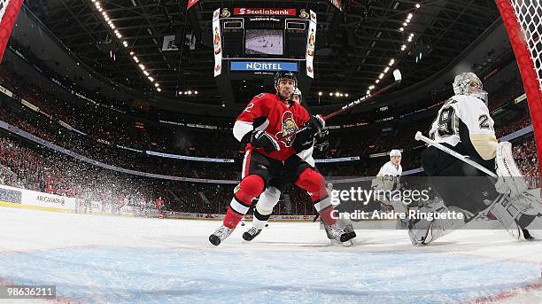 Chris Kelly of the Ottawa Senators crashes the net against Marc-Andre Fleury of the Pittsburgh Penguins in Game Four of the Eastern Conference...