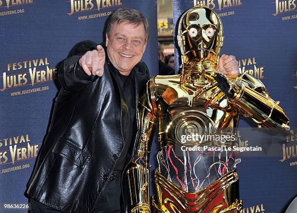 Actor Mark Hamill poses with C-3PO as he attends a Tribute to Star Wars V during the 18th Adventure Film Festival at Le Grand Rex on April 23, 2010...