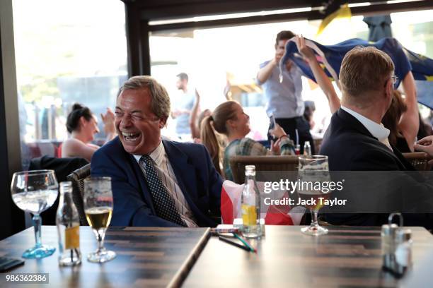 Member of the European Parliament and former Leader of the UK Independence Party Nigel Farage watches England take on Belgium in a World Cup match...