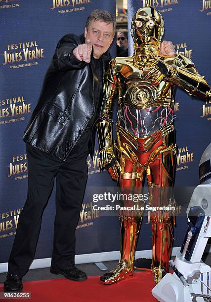 Actor Mark Hamill poses with C-3PO as he attends a Tribute to Star Wars V during the 18th Adventure Film Festival at Le Grand Rex on April 23, 2010...