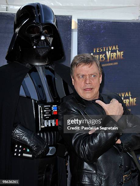 Actor Mark Hamill poses with Darth Vader as he attends a Tribute to Star Wars V during the 18th Adventure Film Festival at Le Grand Rex on April 23,...