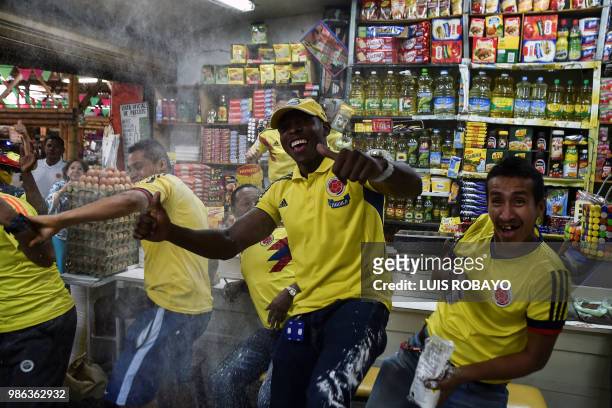 Colombia's national football team supporters celebrate their team's victory against Senegal, during the World Cup group H football match in a popular...