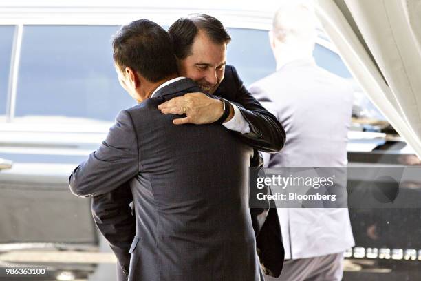 Terry Gou, chairman of Foxconn Technology Group, greets Scott Walker, governor of Wisconsin, ahead of a groundbreaking ceremony for the Foxconn...