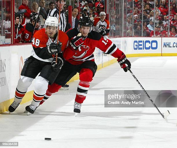 Danny Briere of the Philadelphia Flyers and Travis Zajac of the New Jersey Devils skate for position on a loose puck in Game Five of the Eastern...