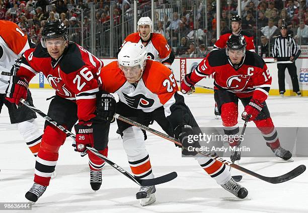 Matt Carle of the Philadelphia Flyers and Patrik Elias of the New Jersey Devils skate for position in Game Five of the Eastern Conference...