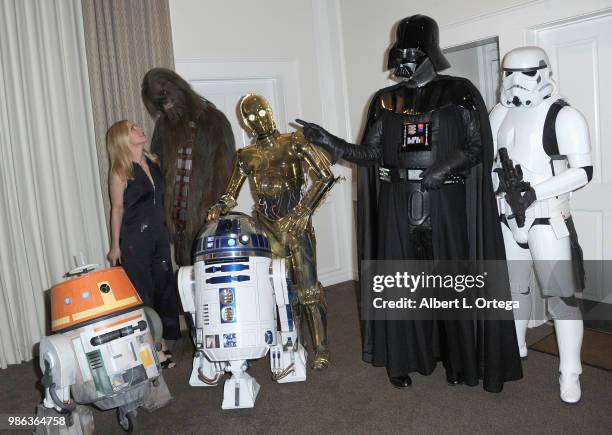 Actress Rhea Seehorn posea with Chewbacca, C3PO, Darth Vader, Storm Trooper, Chopper and R2D2 at the After Party at the Academy Of Science Fiction,...