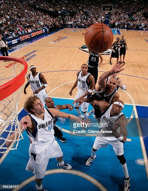 Richard Jefferson of the San Antonio Spurs rebounds against Erick Dampier of the Dallas Mavericks in Game One of the Western Conference Quarterfinals...