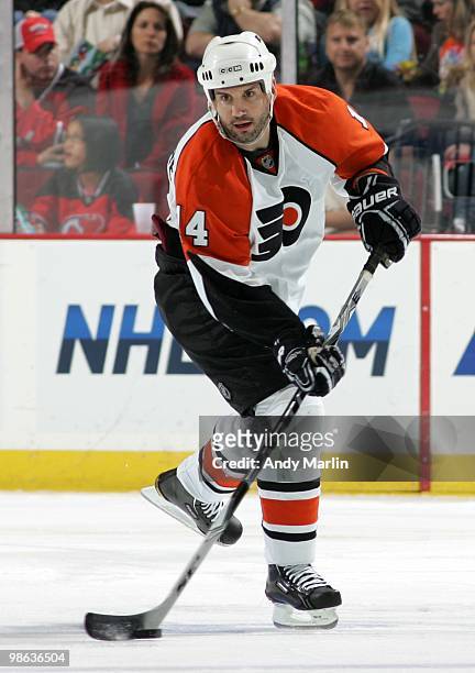 Ian Laperriere of the Philadelphia Flyers plays the puck against the New Jersey Devils in Game Five of the Eastern Conference Quarterfinals during...
