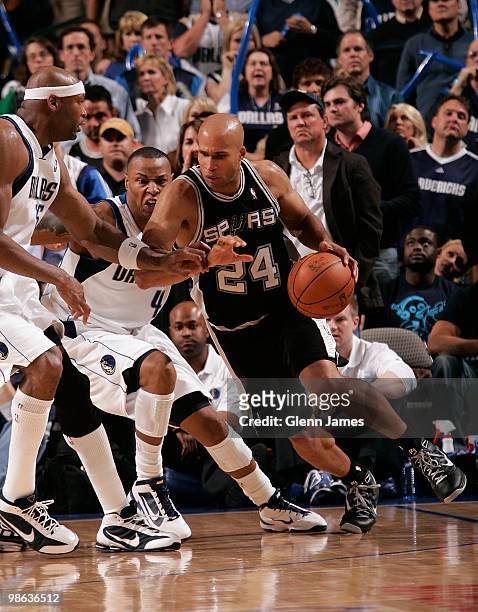 Richard Jefferson of the San Antonio Spurs moves the ball against Caron Butler and Erick Dampier of the Dallas Mavericks in Game One of the Western...