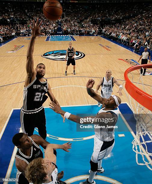 Tim Duncan of the San Antonio Spurs shoots against Erick Dampier of the Dallas Mavericks in Game One of the Western Conference Quarterfinals during...