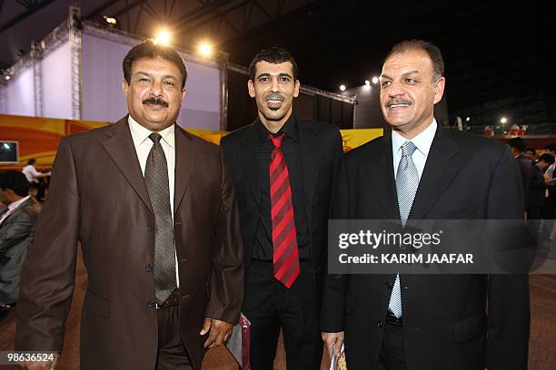 Iraq team head coach Nazem Shaker, Iraqi national team player Yunes Mahmud, and Jordan head coach Adnan Hamad of Iraq pose during the AFC Asian Cup...