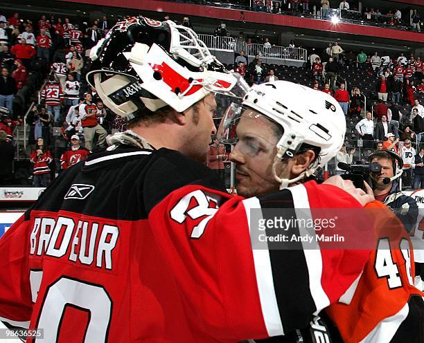 Danny Briere of the Philadelphia Flyers who scored the winning goal is congratulated by Martin Brodeur of the New Jersey Devils after the Flyers...