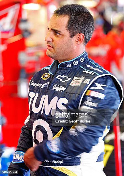 Juan Pablo Montoya, driver of the TUMS Chevrolet, stands in the garage during practice for the NASCAR Sprint Cup Series Aaron's 499 at Talladega...