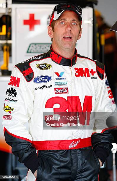 Greg Biffle, driver of the 3M Ford, stands in the garage during practice for the NASCAR Sprint Cup Series Aaron's 499 at Talladega Superspeedway on...