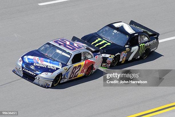 Scott Speed drives the Red Bull Toyota ahead of Robby Gordon, driver of the Monster Energy Toyota, during practice for the NASCAR Sprint Cup Series...