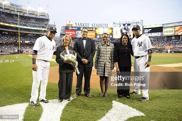 To R: Robinson Cano, Rachel Robinson, two Jackie Robinson Scholars, Sharon Robinson and Marcus Thames pose for a photo prior to the game between the...